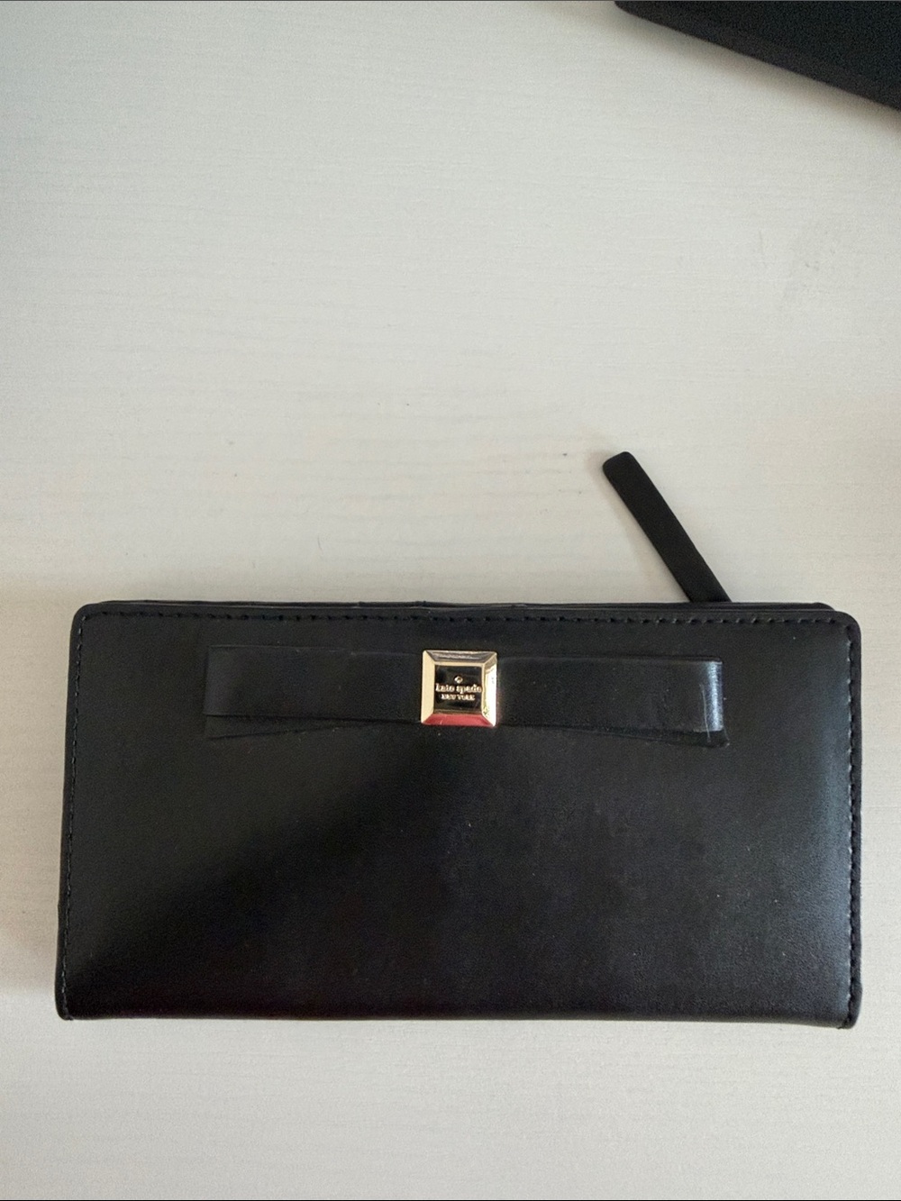 Kate Spade black bow zip-around continental wallet with gold accent